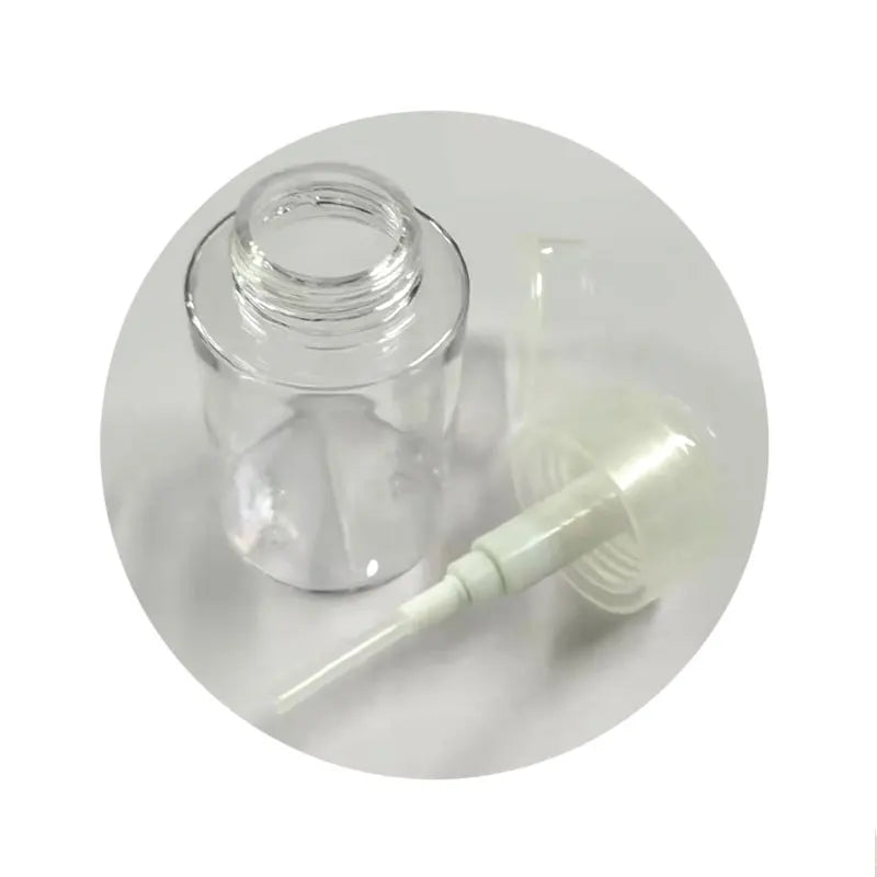 Refillable push-type dispenser bottle for nail polish remover or makeup, with clear plastic body and pump top.