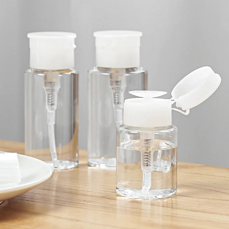 Refillable push-type dispenser bottle for nail polish and makeup remover, clear plastic container with pump for easy use.