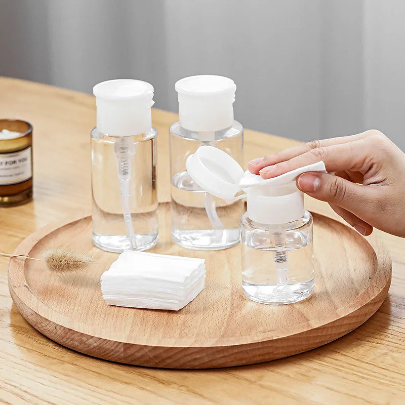 Refillable push-type dispenser bottle for nail polish and makeup remover, clear plastic with pump, designed for easy liquid dispensing.