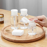 Refillable push-type dispenser bottle for nail polish and makeup remover, clear plastic with pump, designed for easy liquid dispensing.